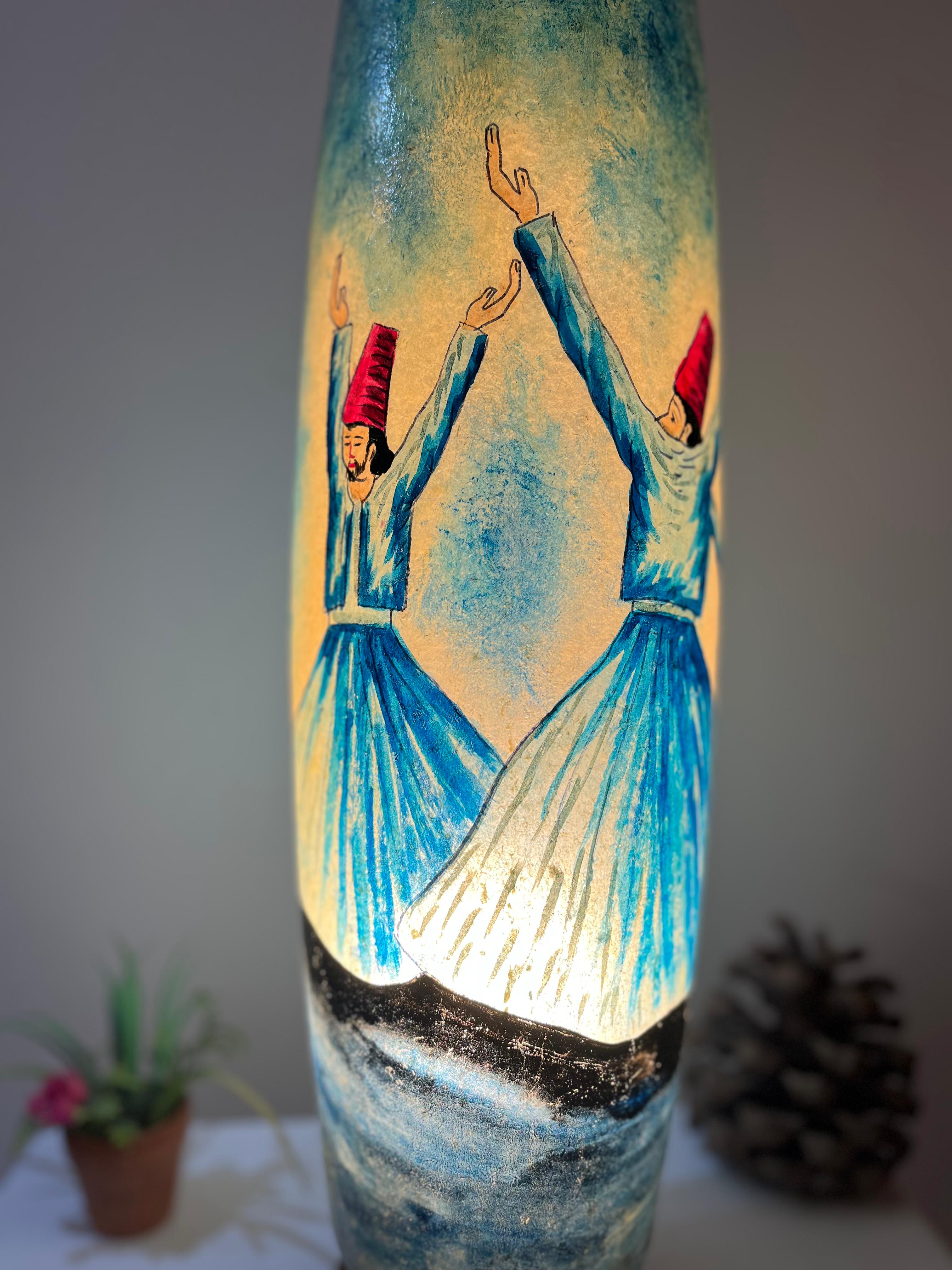 Decorative lamp with painted figures on a gray background
