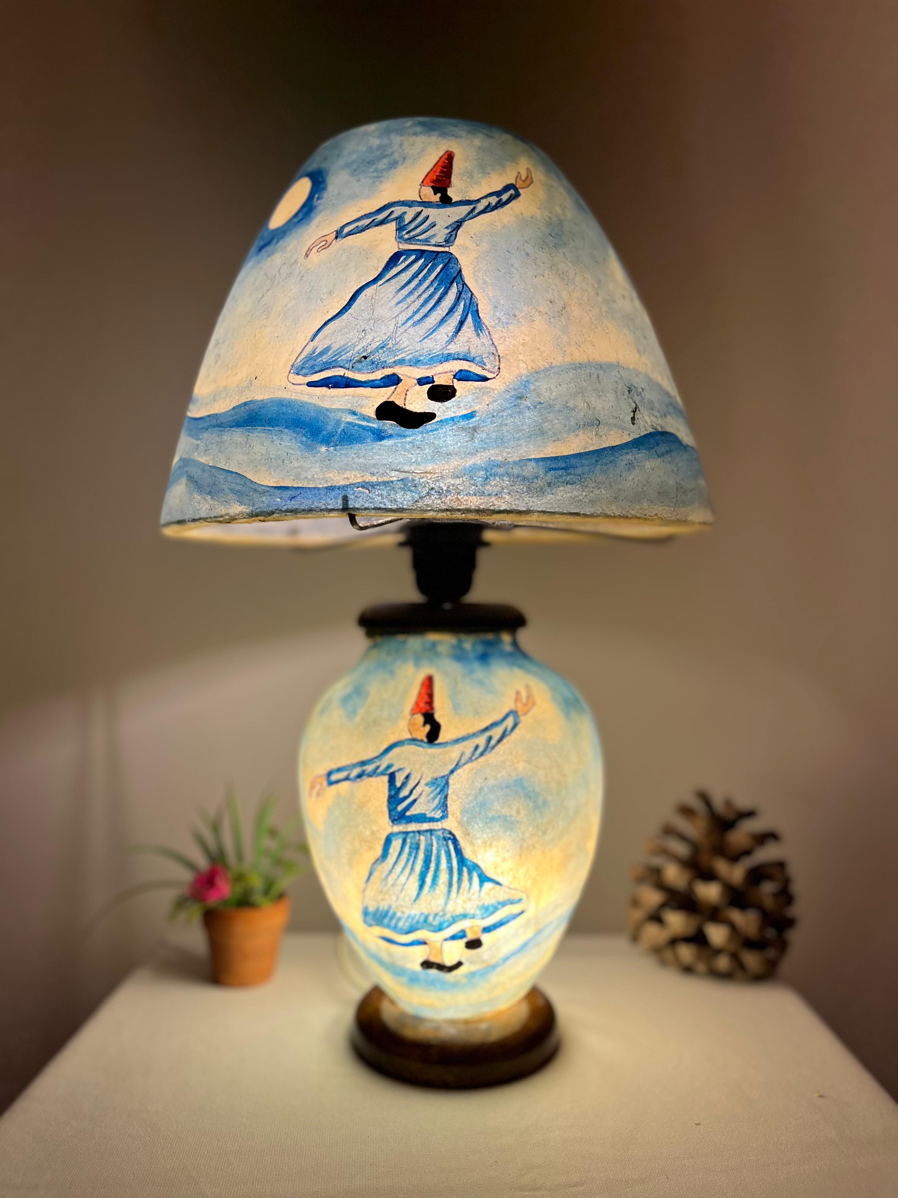 Decorative lamp with artistic design on a plain background